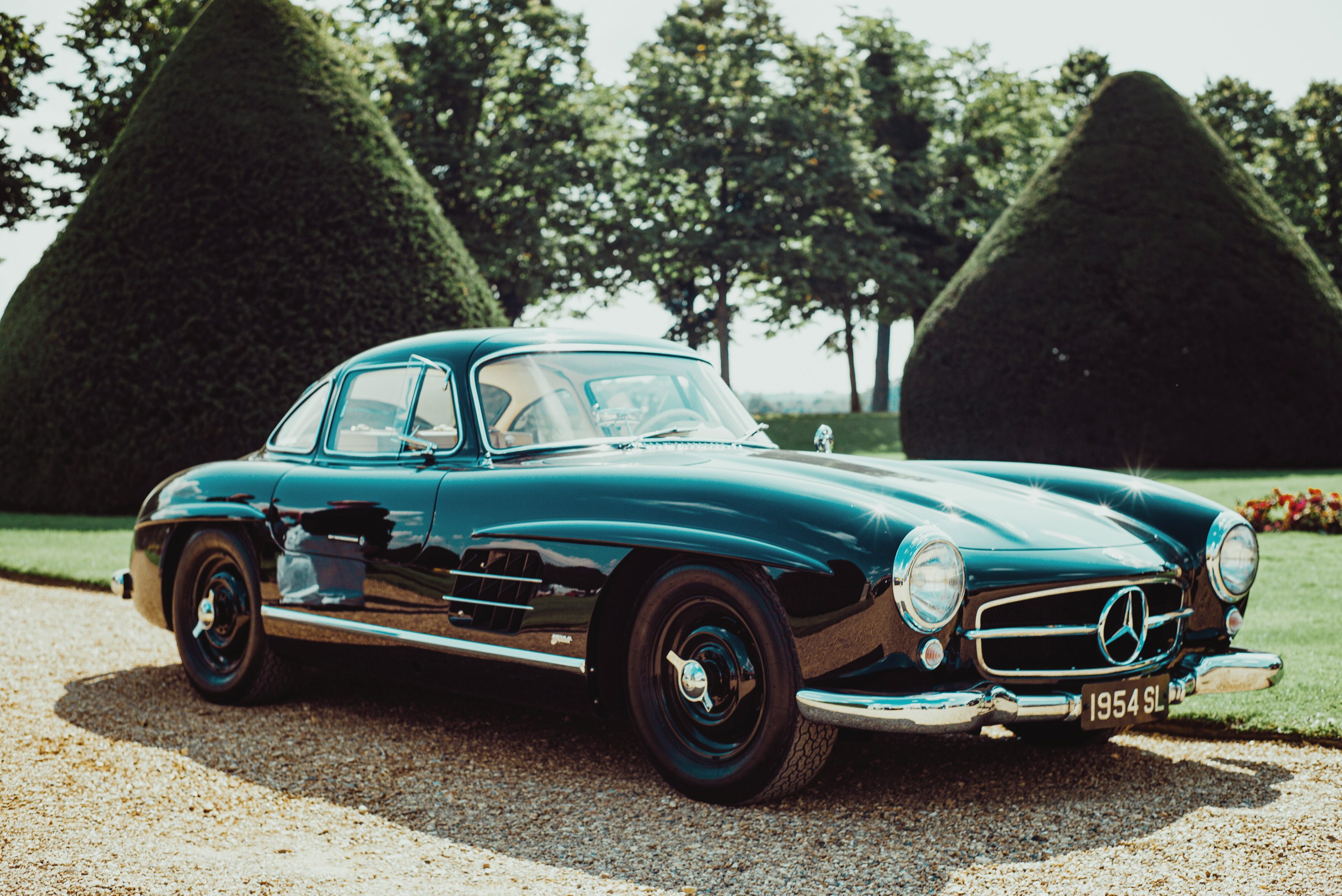 blue classic car on road during daytime